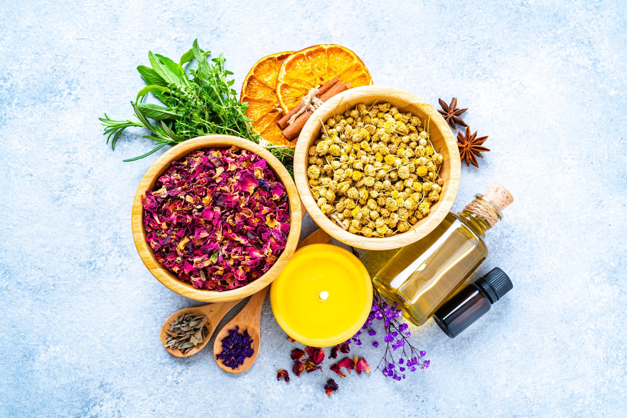 Herbal tea leaves, essential oils, and natural wellness items arranged on a table